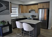 Thumbnail 8 of 9 - A kitchen with a white countertop and a refrigerator at The Laurent at Laurel Apartments, Edmonton, AB, T6T 2T5
