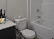 Thumbnail 7 of 9 - A white toilet sits next to a white bathtub in a bathroom at The Laurent at Laurel Apartments, Alberta, T6T 2T5