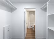 Thumbnail 26 of 31 - A white hallway with a doorway leading to a bathroom.at The Pointe at Riverview, Edmonton, AB