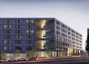 Thumbnail 1 of 7 - A modern building with a lot of windows is shown in the image.
