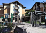 Thumbnail 3 of 10 - a sign in front of an apartment complex