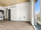 Thumbnail 24 of 35 - A kitchen with a white countertop and a window overlooking a parking lot.