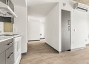 Thumbnail 26 of 35 - A kitchen with a refrigerator, stove, and oven.