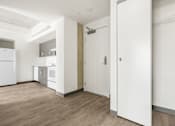 Thumbnail 28 of 35 - A kitchen with white appliances and a white door.