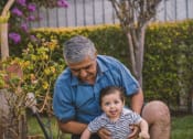 Thumbnail 2 of 4 - a man holding a baby in his lap