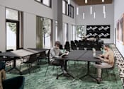 Thumbnail 7 of 7 - Two men are sitting at a table in a room with large windows and a green carpet.