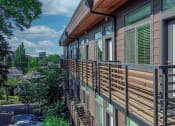 Thumbnail 4 of 10 - a balcony with a wooden railing and a city in the background