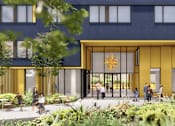 Thumbnail 2 of 7 - A modern building with a yellow entrance and people walking around.