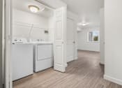 Thumbnail 12 of 13 - A white bathroom with a wooden floor and a window.