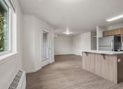 Thumbnail 5 of 13 - A kitchen area with a counter and cabinets.