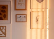 Thumbnail 6 of 15 - a shelf with two lanterns and pictures on the wall