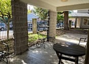 Thumbnail 1 of 5 - A patio with a table and chairs is shown.