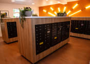 Thumbnail 15 of 25 - the lockers in the front of a room with yellow lights and a wooden floor