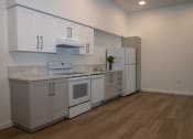 Thumbnail 5 of 25 - the preserve at ballantyne commons apartment kitchen with white cabinets and appliances