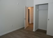 Thumbnail 7 of 25 - a bedroom with a closet and a door into a hallway