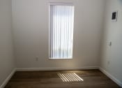Thumbnail 8 of 25 - a window in the corner of a room with a wooden floor
