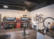 Thumbnail 15 of 16 - A bike shop with a variety of bikes and tools.
