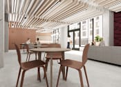 Thumbnail 12 of 30 - A modern dining room with a table set for two and a potted plant on the side.