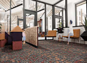 Thumbnail 18 of 30 - A room with a red carpet and a variety of seating options including chairs and a couch.