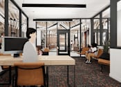 Thumbnail 13 of 30 - A person is sitting at a desk in a modern office space.