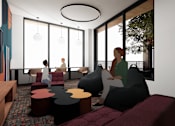 Thumbnail 26 of 30 - A modern living room with a person sitting on a bean bag chair.