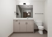 Thumbnail 3 of 30 - A bathroom with a toilet, sink, and medicine cabinet.