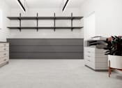 Thumbnail 2 of 30 - A modern kitchen with white cabinets and a grey countertop.