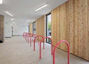Thumbnail 30 of 41 - A long hallway with red handles on the wall.