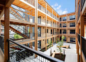 Thumbnail 24 of 41 - A view of a courtyard from a second floor balcony.