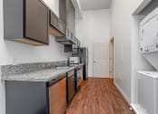 Thumbnail 6 of 10 - a kitchen with stainless steel appliances and granite countertops