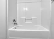 Thumbnail 7 of 10 - a white bathtub with a silver faucet