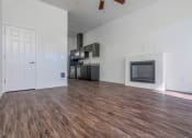 Thumbnail 2 of 10 - a living room with a fireplace and a kitchen