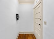Thumbnail 9 of 35 - A white door with a keyhole and a black security system.