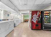 Thumbnail 34 of 35 - A red Dr Pepper vending machine is on the right side of a laundromat.
