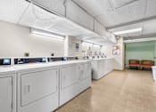 Thumbnail 35 of 35 - A laundry room with washers and dryers.
