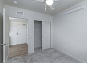 Thumbnail 33 of 38 - A room with a white ceiling, a white door, and a white wall.