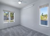 Thumbnail 27 of 38 - A room with a ceiling fan and two windows.