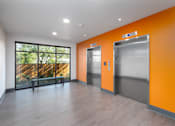Thumbnail 14 of 38 - A room with orange walls and a wooden floor.
