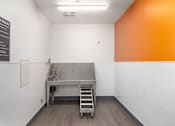 Thumbnail 22 of 38 - A clean and empty pet wash room with a sign on the wall.