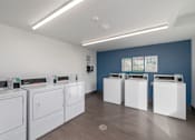 Thumbnail 20 of 38 - A row of washing machines in a laundromat.