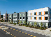 Thumbnail 8 of 38 - A street view of a residential area with apartment buildings.
