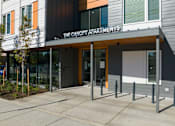 Thumbnail 12 of 38 - The Canopy Apartments is a modern building with a black and white exterior.