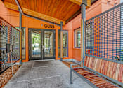 Thumbnail 3 of 21 - A building with a wooden roof and a bench in front of it.