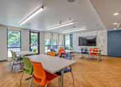 Thumbnail 5 of 21 - A conference room with a long table and chairs.