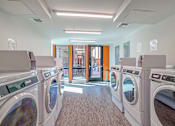 Thumbnail 8 of 21 - A row of washing machines in a laundromat.