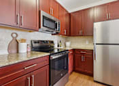 Thumbnail 2 of 38 - Kitchen with Brown Cabinets at New Britain, Chalfont, PA, 18914