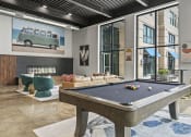 Thumbnail 30 of 76 - a pool table in the clubhouse at the bradley braddock road station apartments at The Icon, Richmond, VA 23230