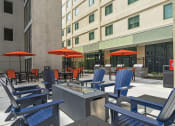 Thumbnail 42 of 76 - a patio with chairs and umbrellas in front of a building  at The Icon, Richmond, VA, 23230