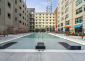 Thumbnail 48 of 76 - a swimming pool in the middle of two buildings  at The Icon, Richmond, VA 23230