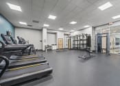 Thumbnail 65 of 76 - a large fitness room with treadmills and other exercise equipment  at The Icon, Richmond, VA, 23230